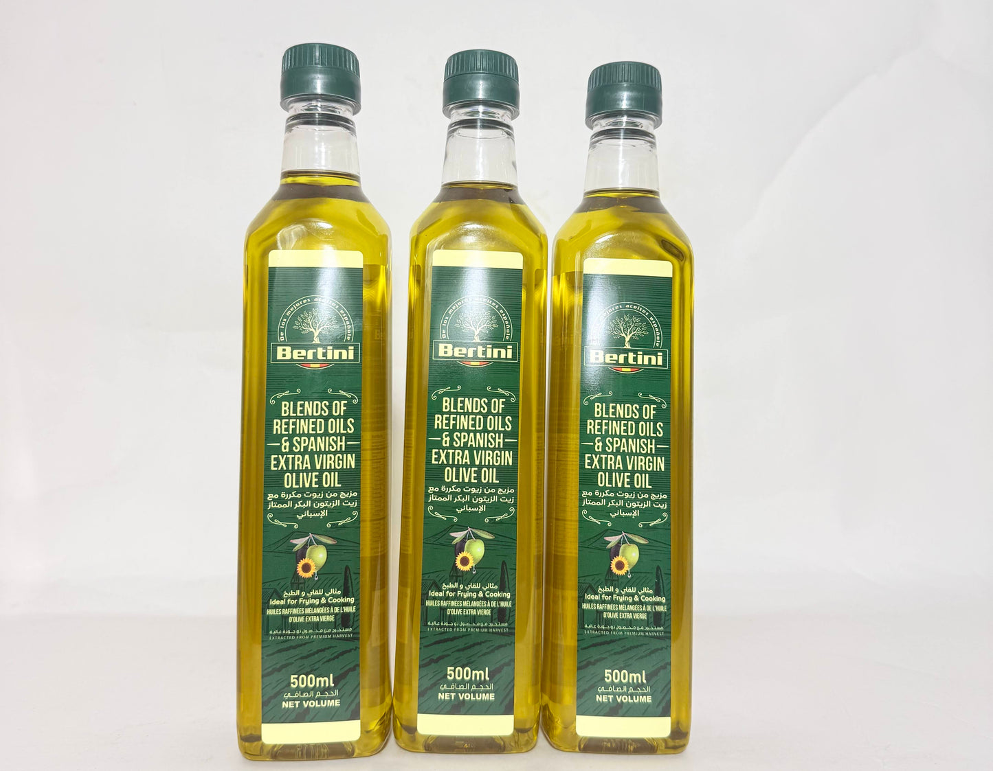 Three bottles of Bertini olive oil on a white background