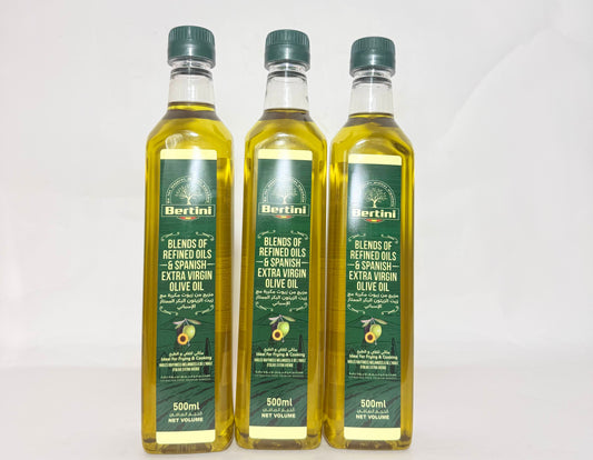 Three bottles of Bertini olive oil on a white background
